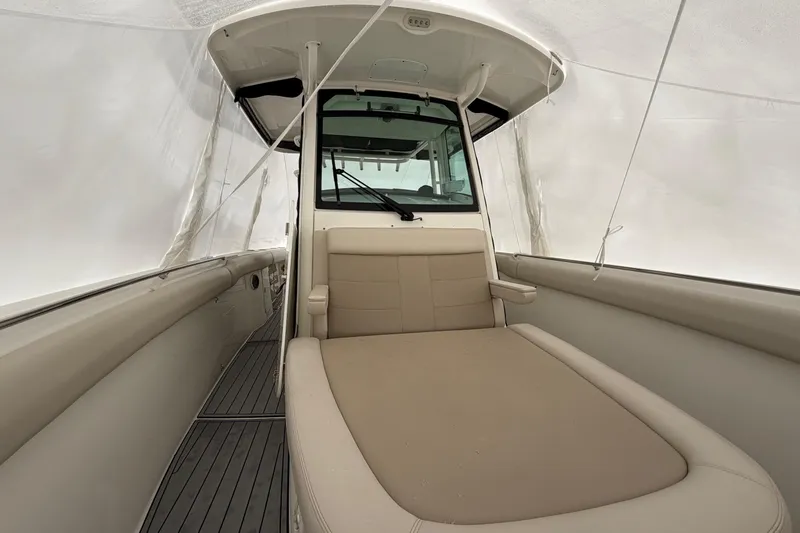 Slide: The Image of 2018 Boston Whaler 330 Outrage interior with cushioned seating and sleek design. - 23