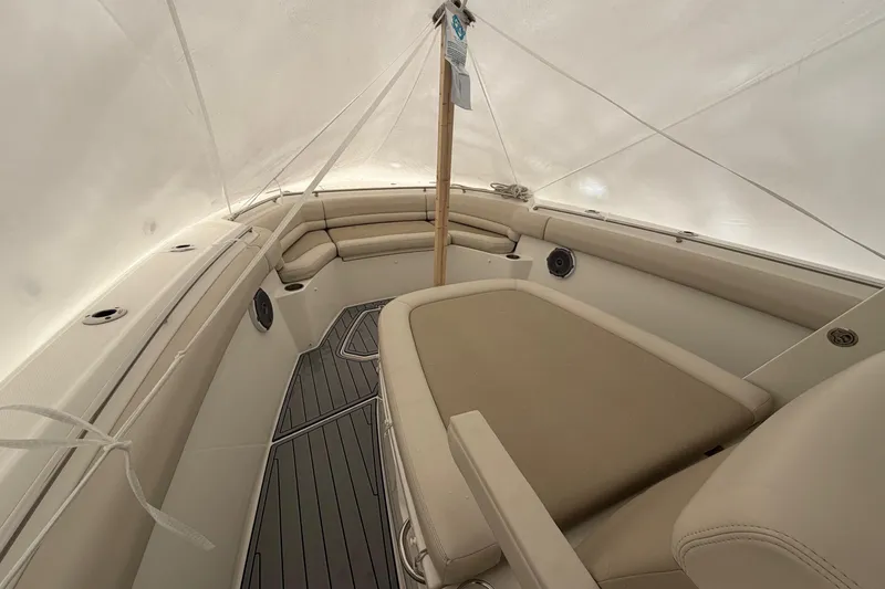 Slide: The Image of 2018 Boston Whaler 330 Outrage interior with beige seating and sleek design. - 25