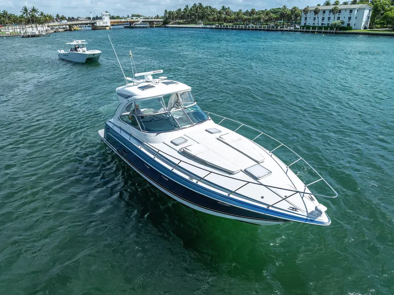 Slide: The Image of 2022 Formula 40 PC yacht cruising on clear blue water near a coastal area. - 11