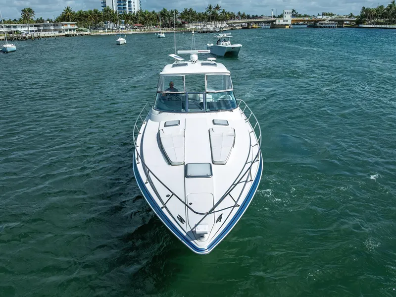 Slide: The Image of 2022 Formula 40 PC yacht cruising on a scenic waterway with palm trees in the background. - 12