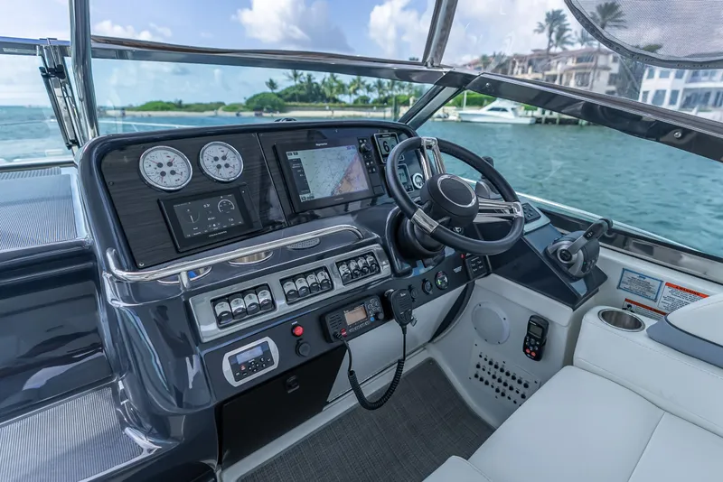 Slide: The Image of 2022 Formula 40 PC yacht cockpit with modern navigation and control systems, overlooking serene waters. - 15