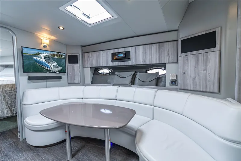 Slide: The Image of Luxurious 2022 Formula 40 PC yacht interior with white seating, table, and mounted TV. - 37