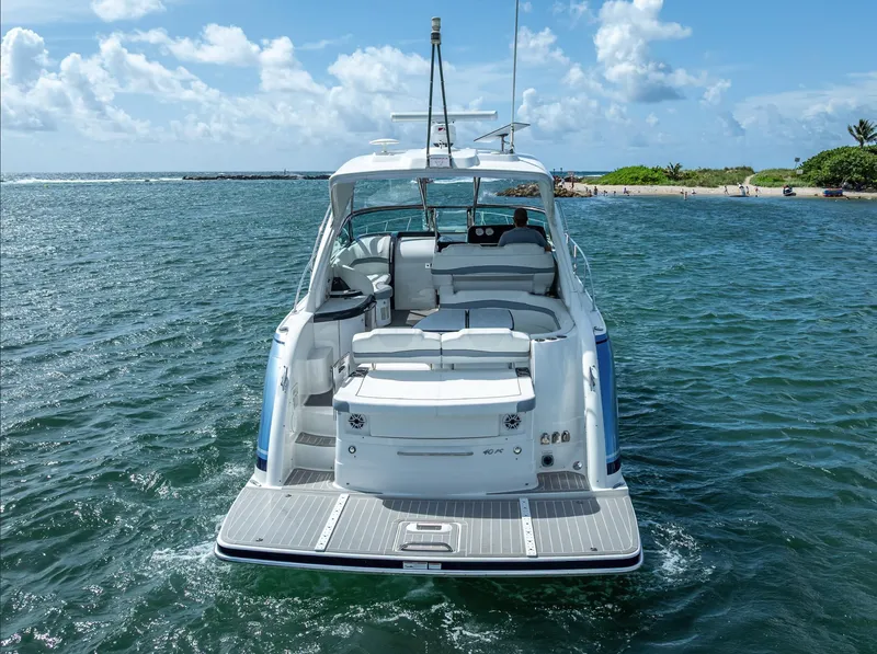 Slide: The Image of 2022 Formula 40 PC yacht on open water, rear view, clear sky, and distant shoreline. - 4