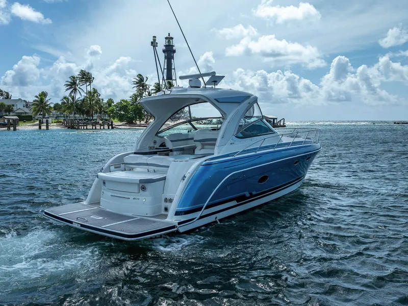 Slide: The Image of 2022 Formula 40 PC yacht cruising near tropical shoreline with lighthouse in background. - 6