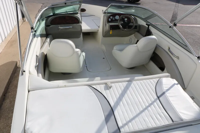 Slide: The Image of 2004 Caravelle 187 Fish & Ski boat interior with white seating and dashboard view. - 13