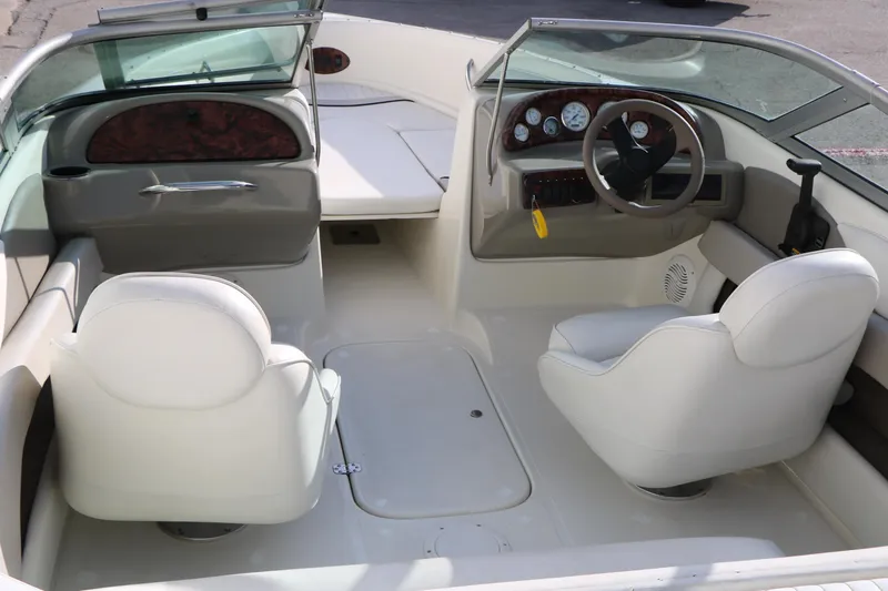 Slide: The Image of 2004 Caravelle 187 Fish & Ski boat interior with white seating and dashboard controls. - 14
