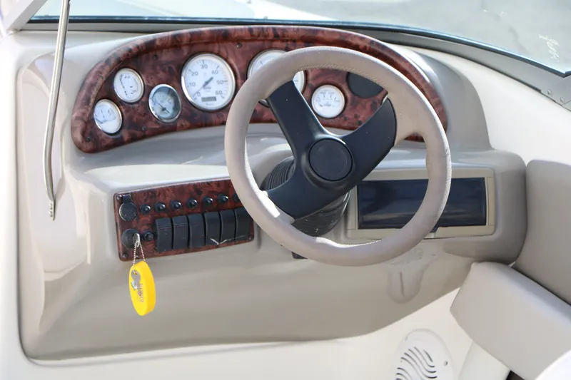 Slide: The Image of 2004 Caravelle 187 Fish & Ski boat dashboard with steering wheel and gauges. - 16