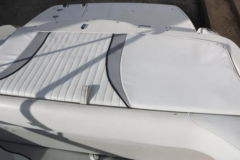 Slide: The Image of 2004 Caravelle 187 Fish & Ski boat with white cushioned seating area. - 21