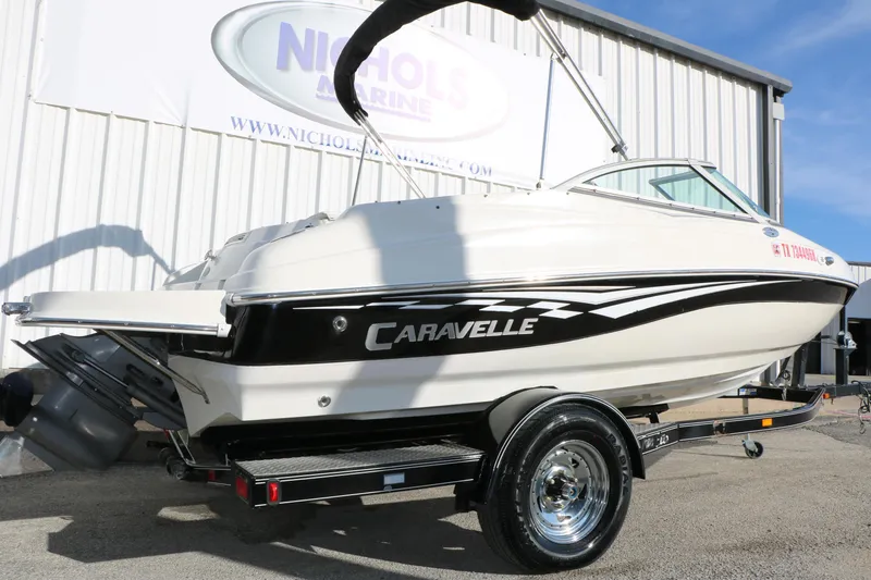 Slide: The Image of 2004 Caravelle 187 Fish & Ski boat on trailer, parked outside a marine dealership. - 3