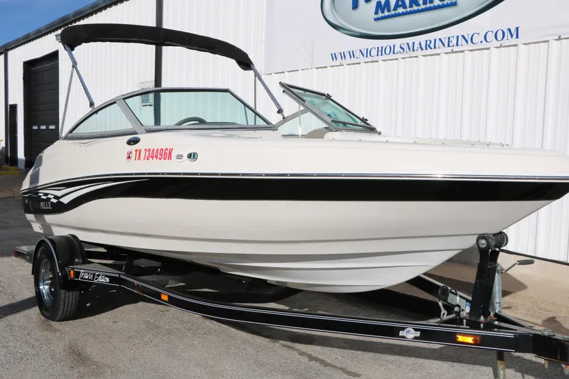 Slide: The Image of 2004 Caravelle 187 Fish & Ski boat on trailer, parked outside Nichols Marine. - 6