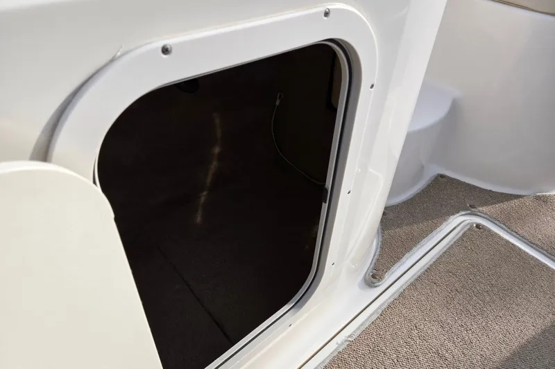 Slide: The Image of 2002 Chaparral Sunesta 242 boat interior hatch with carpeted flooring. - 13