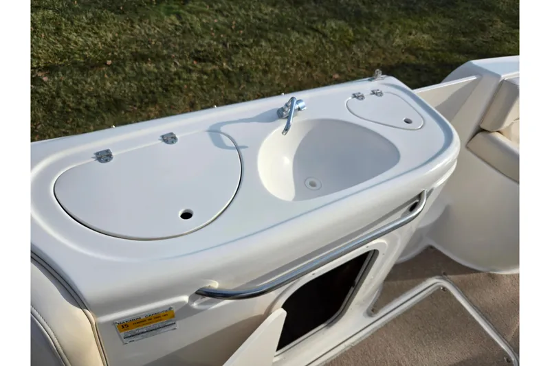 Slide: The Image of 2002 Chaparral Sunesta 242 boat sink and storage area on deck. - 14