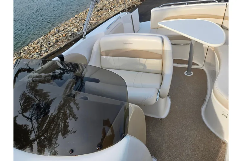 Slide: The Image of 2002 Chaparral Sunesta 242 boat interior with seating and table by the water. - 22