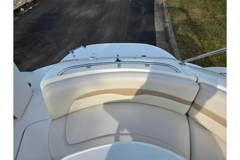 Slide: The Image of 2002 Chaparral Sunesta 242 boat interior with white and beige seating. - 24
