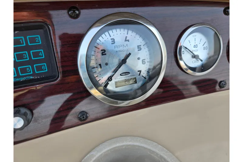 Slide: The Image of Dashboard of 2002 Chaparral Sunesta 242 boat showing RPM and oil pressure gauges. - 26