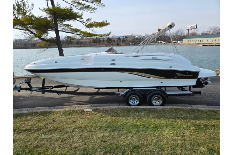 Slide: The Image of 2002 Chaparral Sunesta 242 boat on trailer by a lakeside, ready for adventure. - 9