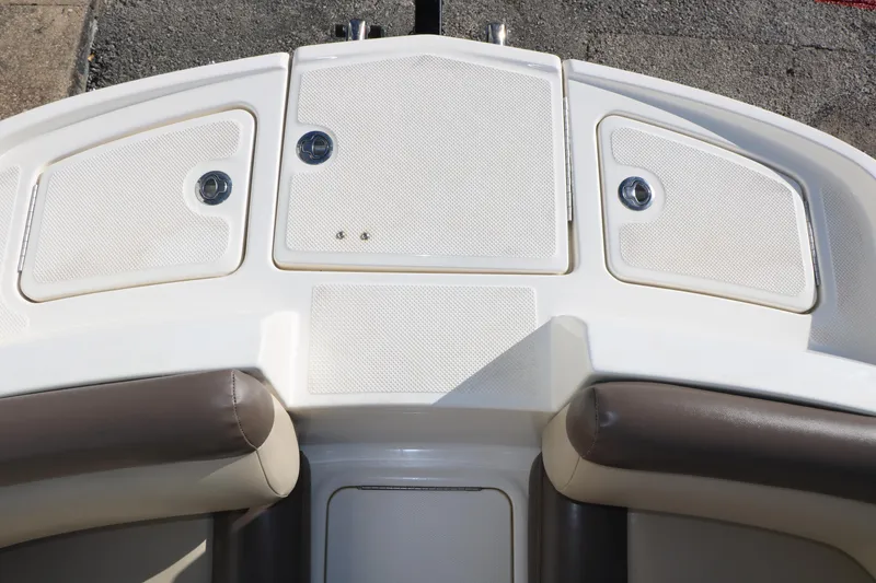 Slide: The Image of 2017 Bayliner 195 Deck Boat interior with storage compartments and cushioned seating. - 17