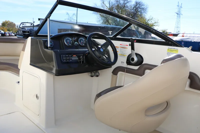 Slide: The Image of 2017 Bayliner 195 Deck Boat interior with steering wheel and dashboard controls. - 19
