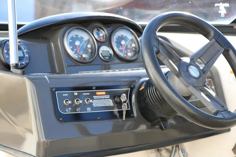 Slide: The Image of 2017 Bayliner 195 Deck Boat dashboard with steering wheel and instrument panel. - 20