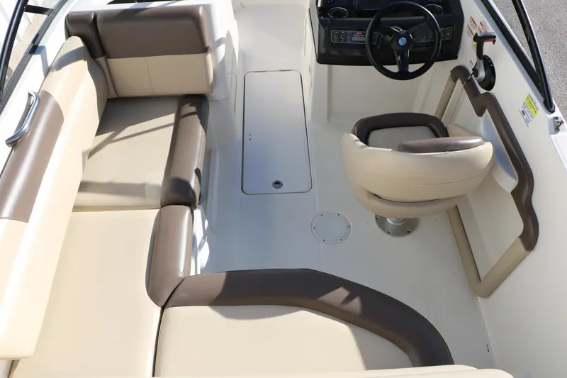 Slide: The Image of 2017 Bayliner 195 Deck Boat interior with beige seating and steering console. - 23