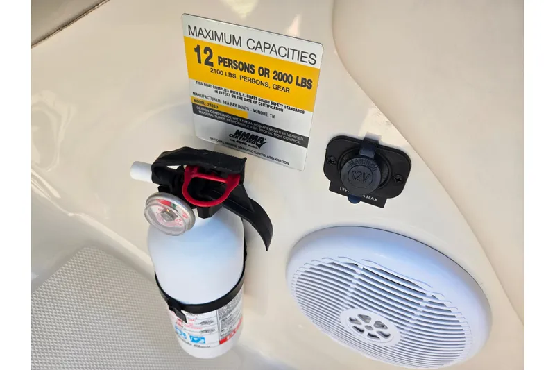 Slide: The Image of 2005 Sea Ray 240 Sundeck capacity label, fire extinguisher, speaker, and 12V outlet. - 14