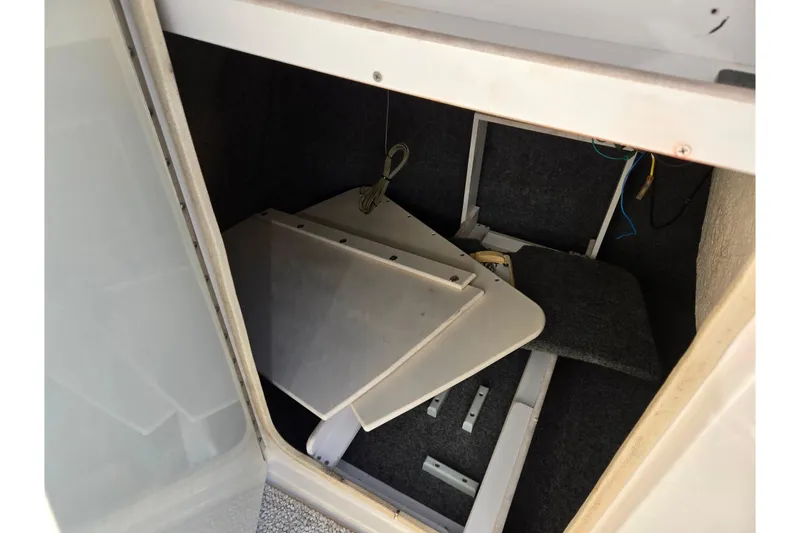 Slide: The Image of Storage compartment in a 2005 Sea Ray 240 Sundeck boat, containing removable panels. - 16