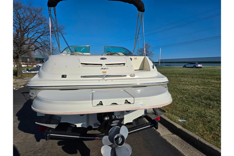Slide: The Image of 2005 Sea Ray 240 Sundeck boat, rear view, parked on a sunny day. - 2