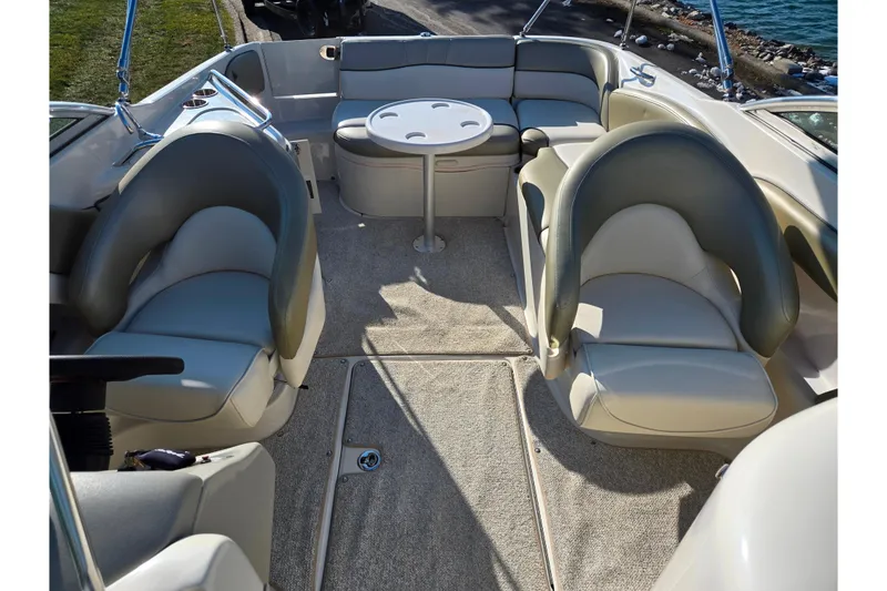 Slide: The Image of 2005 Sea Ray 240 Sundeck interior with seating and table, showcasing luxury boat design. - 21