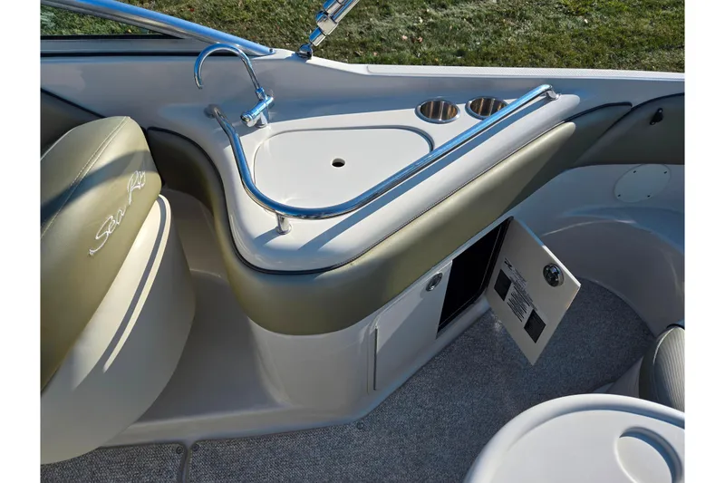 Slide: The Image of 2005 Sea Ray 240 Sundeck interior with sink and storage compartments. - 23
