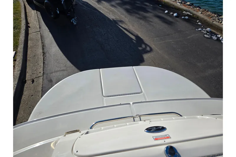 Slide: The Image of 2005 Sea Ray 240 Sundeck boat on trailer near waterfront. - 27