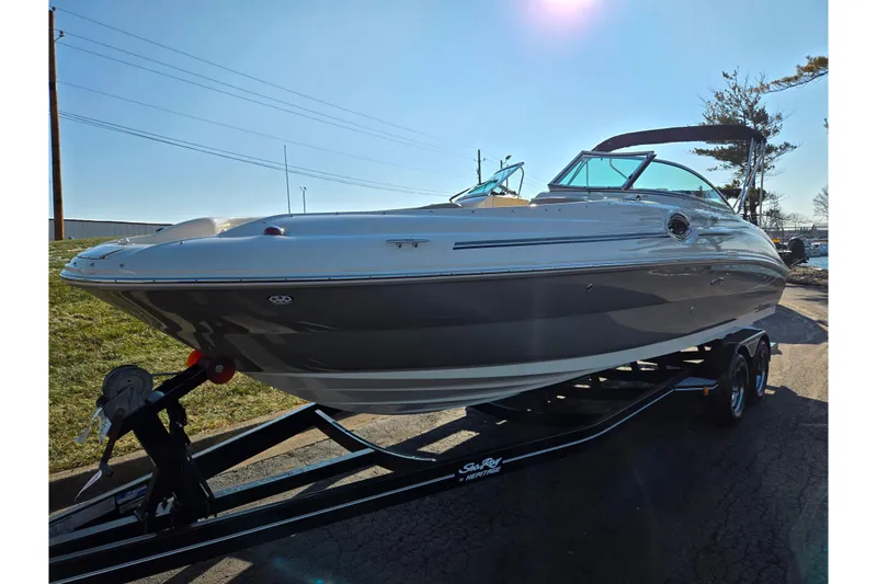 Slide: The Image of 2005 Sea Ray 240 Sundeck boat on trailer under clear blue sky. - 5