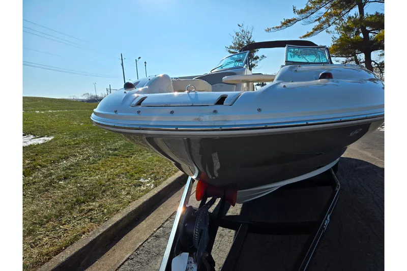 Slide: The Image of 2005 Sea Ray 240 Sundeck boat on trailer, parked outdoors on a sunny day. - 6