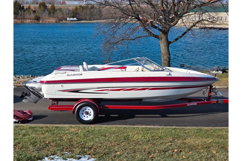 The Image of 2007 Glastron GT 205 Ski & Fish boat on trailer by a lake. - 0