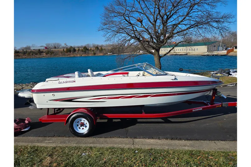 Slide: The Image of 2007 Glastron GT 205 Ski & Fish boat on trailer by a lake. - 10