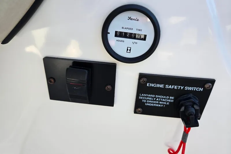 Slide: The Image of 2007 Glastron GT 205 Ski & Fish dashboard with hour meter and engine safety switch. - 14