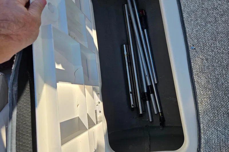 Slide: The Image of Storage compartment in a 2007 Glastron GT 205 Ski & Fish boat with metal rods. - 16