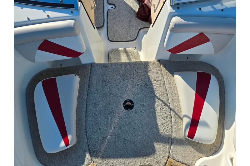 Slide: The Image of 2007 Glastron GT 205 Ski & Fish boat interior with red accents and carpeted flooring. - 19