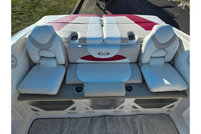 Slide: The Image of 2007 Glastron GT 205 Ski & Fish boat interior with cushioned seating and cup holders. - 22