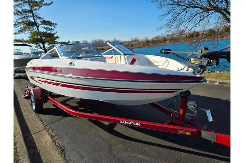 Slide: The Image of 2007 Glastron GT 205 Ski & Fish boat on trailer by a lake. - 9