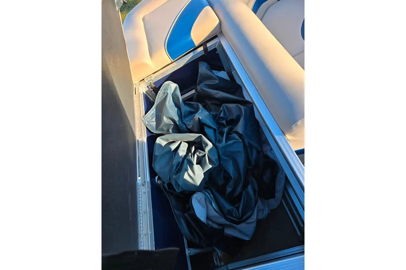 Slide: The Image of Storage compartment in a 2012 Berkshire 190CL LSR boat with fabric inside. - 16