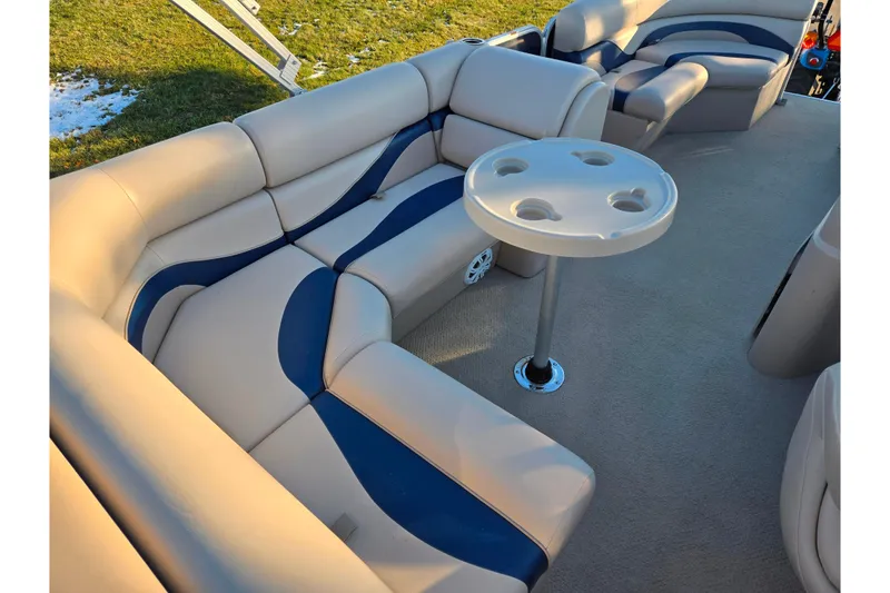 Slide: The Image of Luxurious seating area on a 2012 Berkshire 190CL LSR pontoon boat with cupholder table. - 17