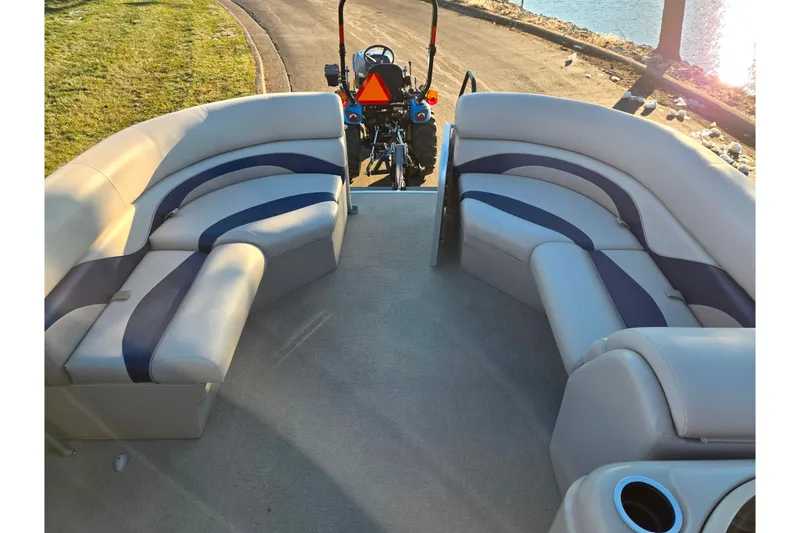 Slide: The Image of 2012 Berkshire 190CL LSR pontoon boat interior with plush seating and cup holders. - 21