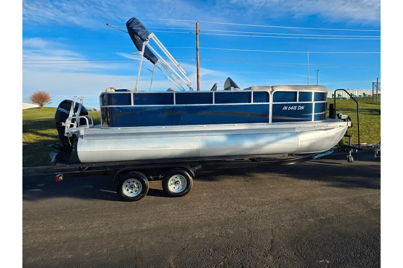 Slide: The Image of 2012 Berkshire 190CL LSR pontoon boat on trailer, blue and silver design. - 4