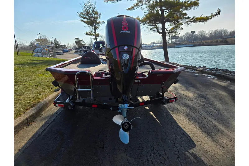 Slide: The Image of 2019 Vexus AVX1980 boat with powerful engine, parked near a scenic lake. - 2