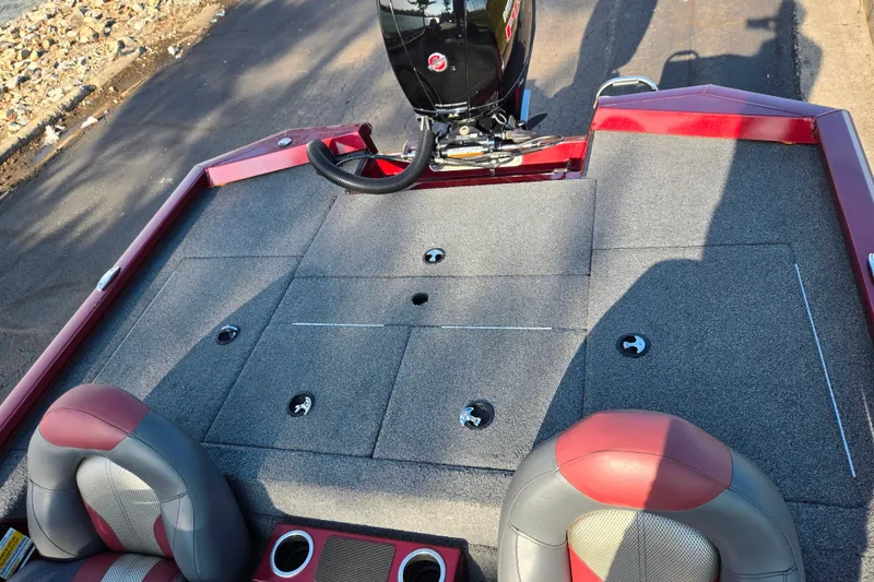 Slide: The Image of 2019 Vexus AVX1980 boat interior with red and gray seating, carpeted deck, and motor. - 22