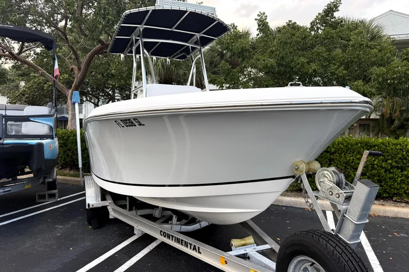 The Image of 2019 Release 208RX boat on trailer under clear blue sky. - 0