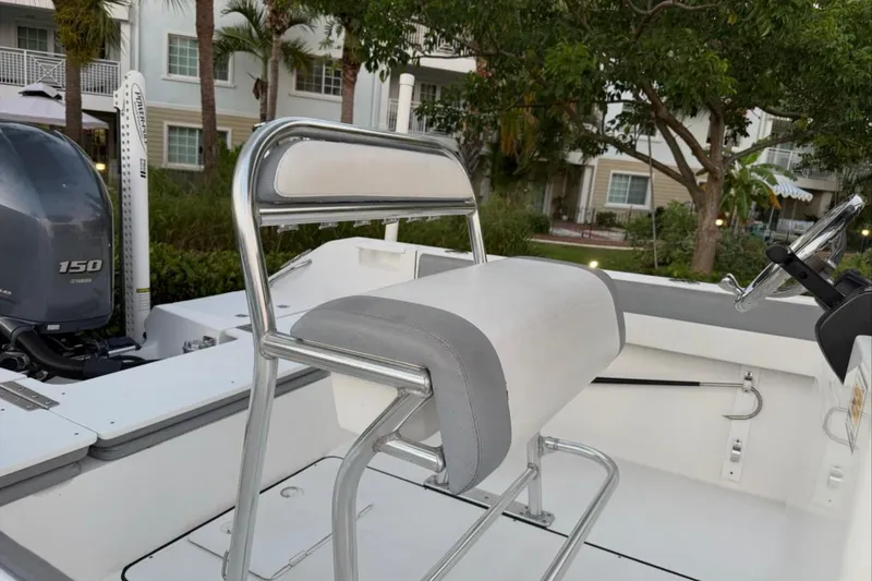 Slide: The Image of 2019 Release 208RX boat interior at dealership, showcasing helm and seating area. - 14