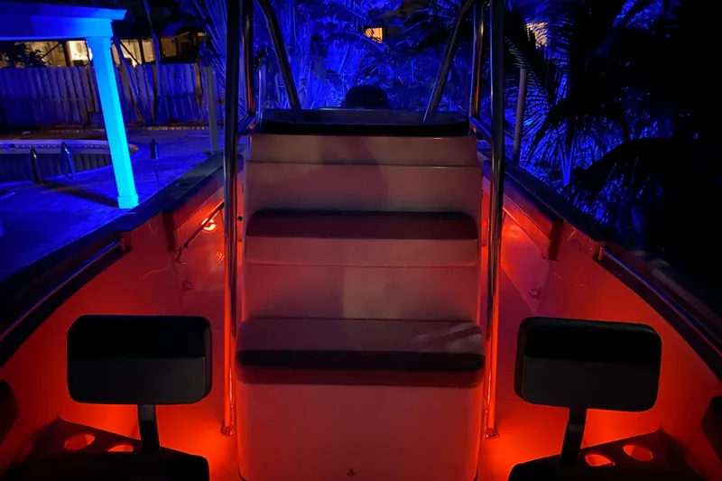 Slide: The Image of 2019 Release 208RX boat for sale at dealership, featuring spacious deck and control console. - 16