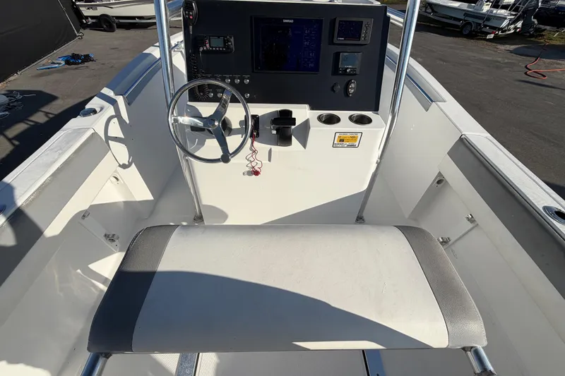 Slide: The Image of Cockpit view of 2019 Release 208RX boat with steering wheel and control panel. - 20