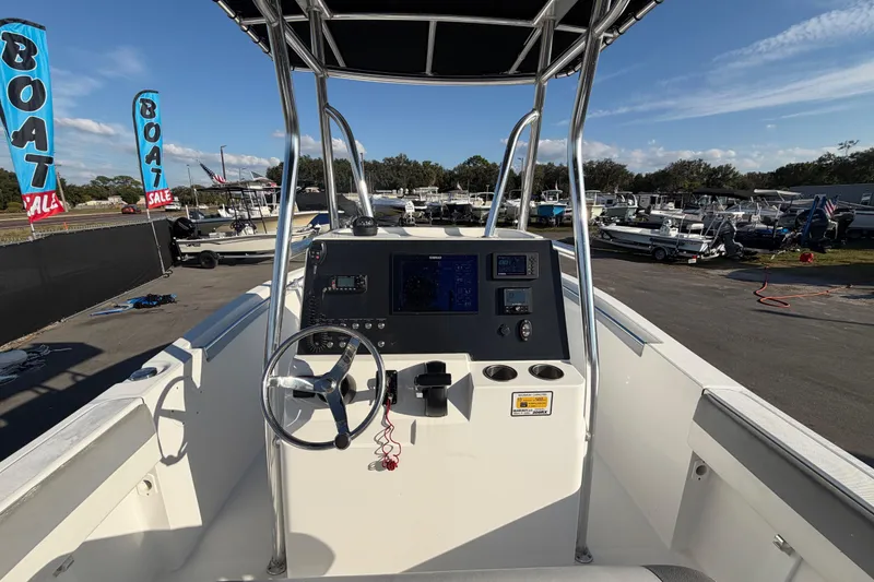 Slide: The Image of 2019 Release 208RX boat dashboard with steering wheel, displayed at a boat sale event. - 21